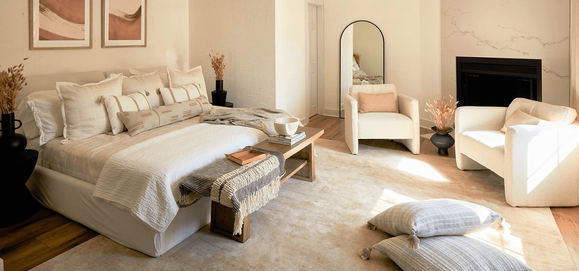 A cozy and stylish bedroom with a large bed, neutral tones, and modern furnishings.