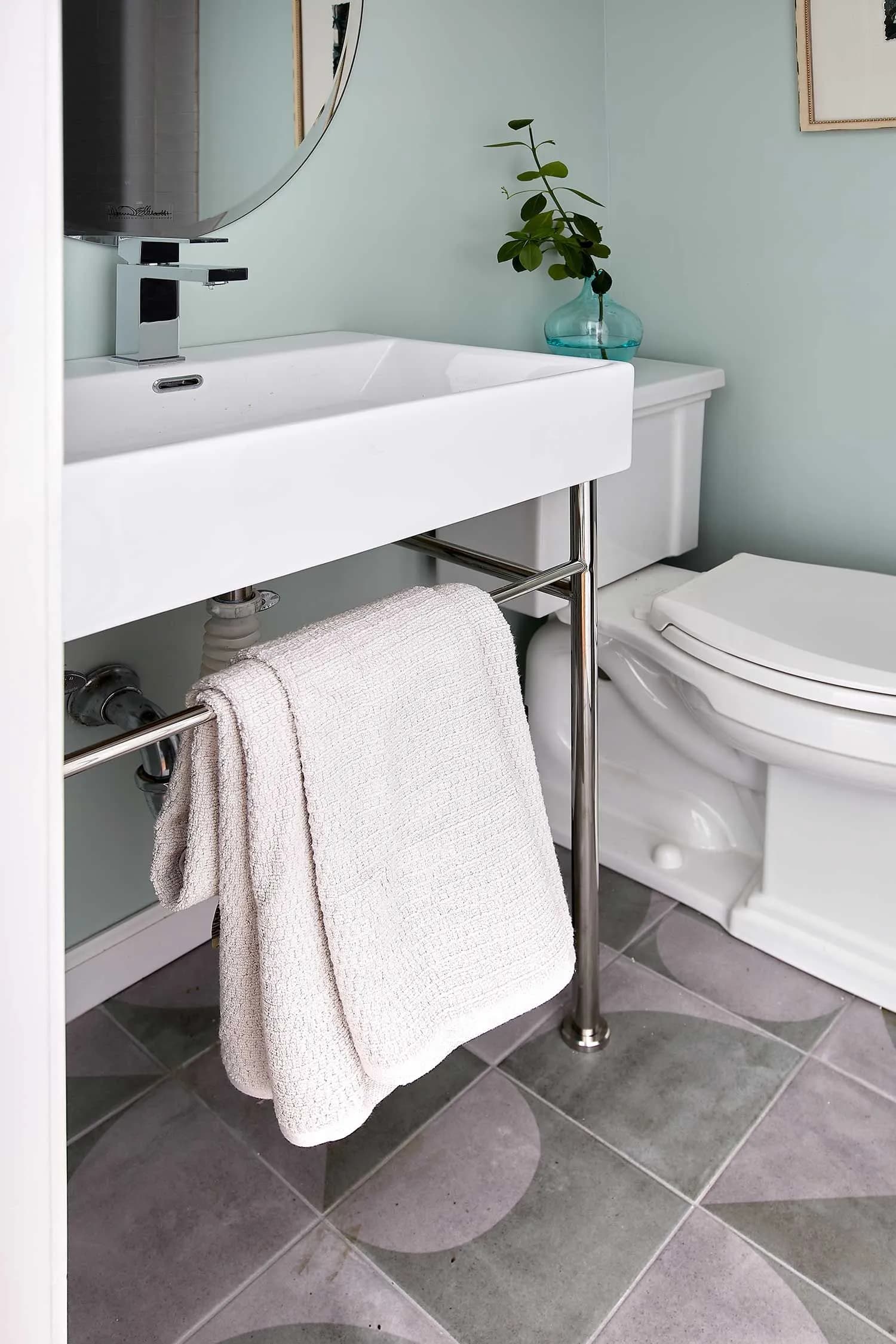 Contemporary bathroom with vessel sink and patterned floor.