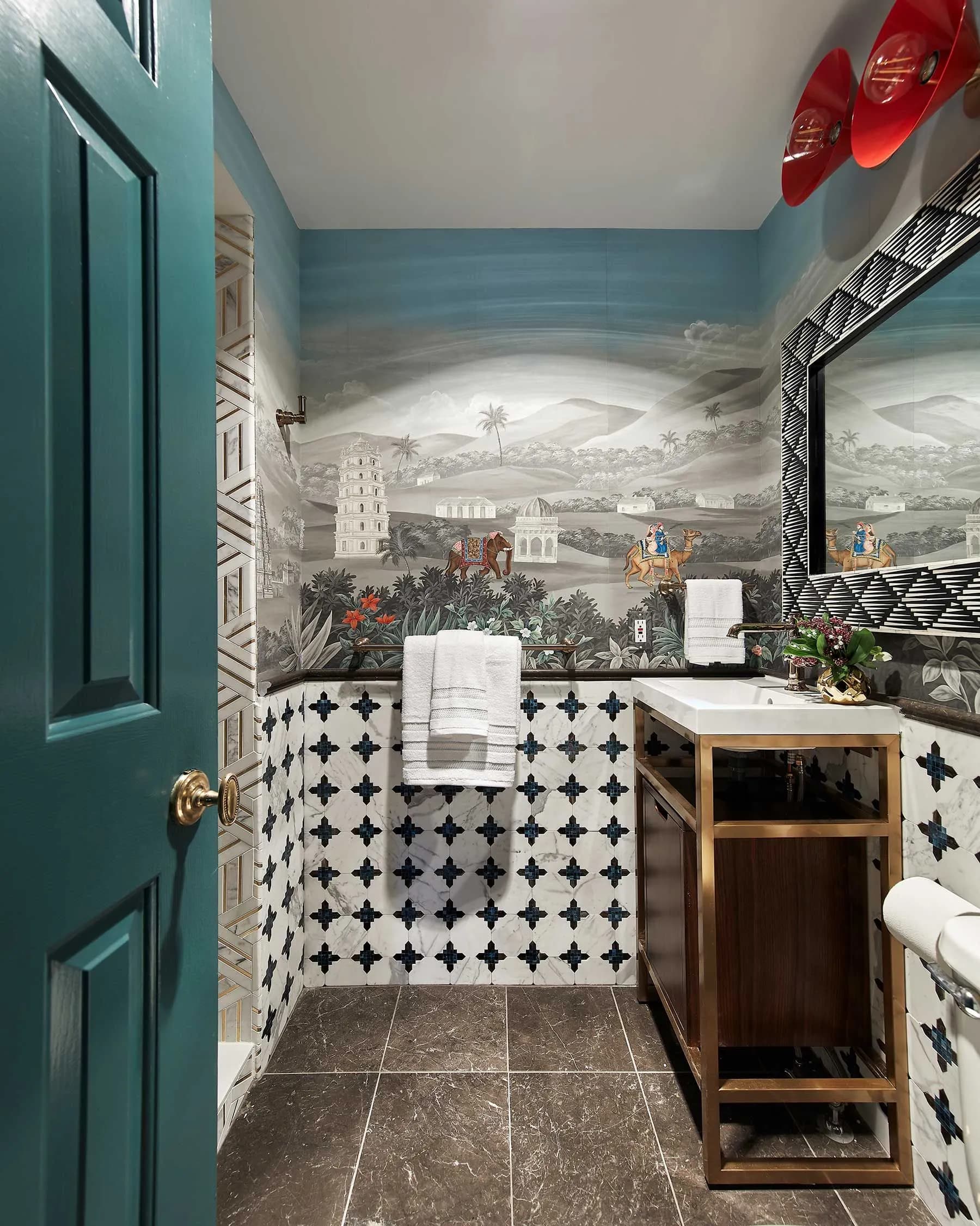 Elegant bathroom with scenic mural wallpaper, patterned tiles, and a modern vanity with gold accents.