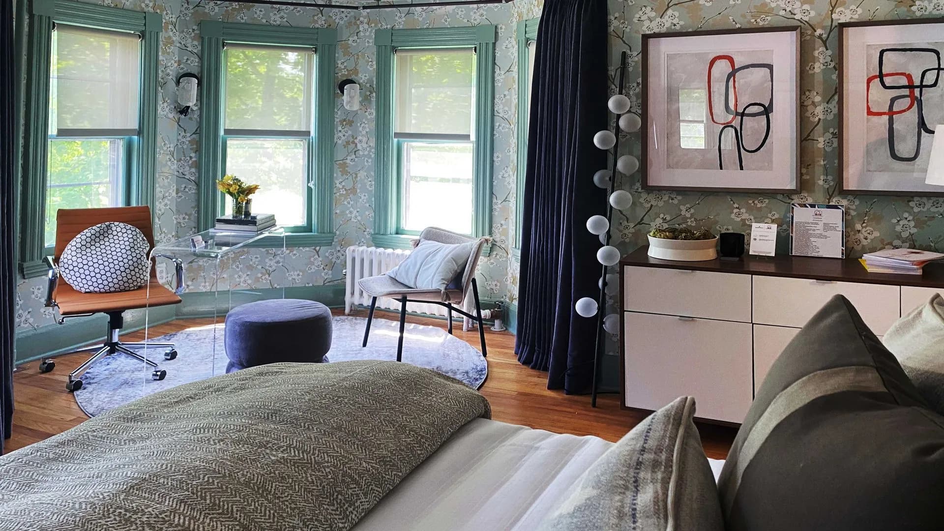 Another view of the vibrant room showcasing large windows with a seating area with two chairs