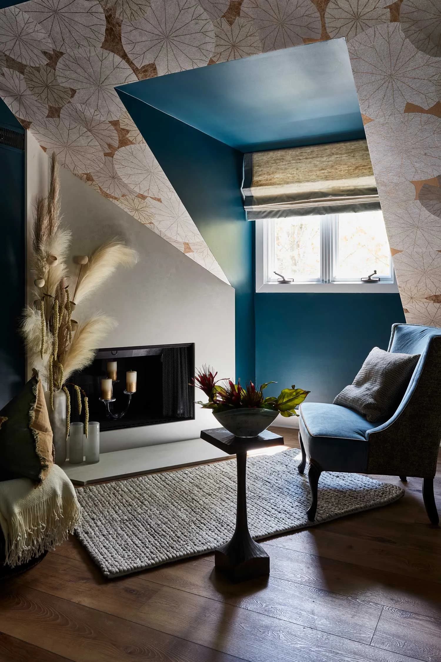 Modern sitting room with fireplace and blue accent wall.