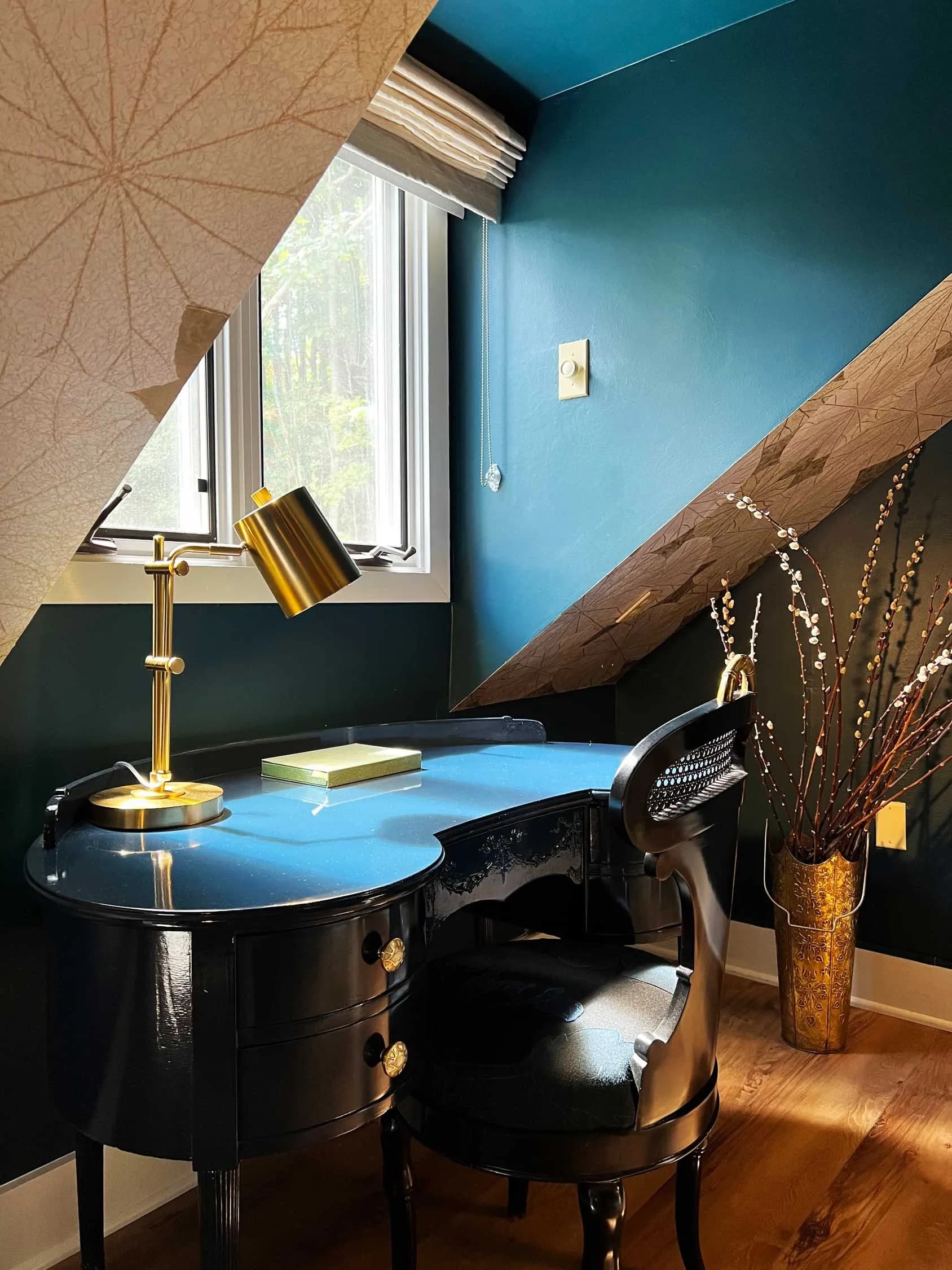 Blue study nook with desk and chair.