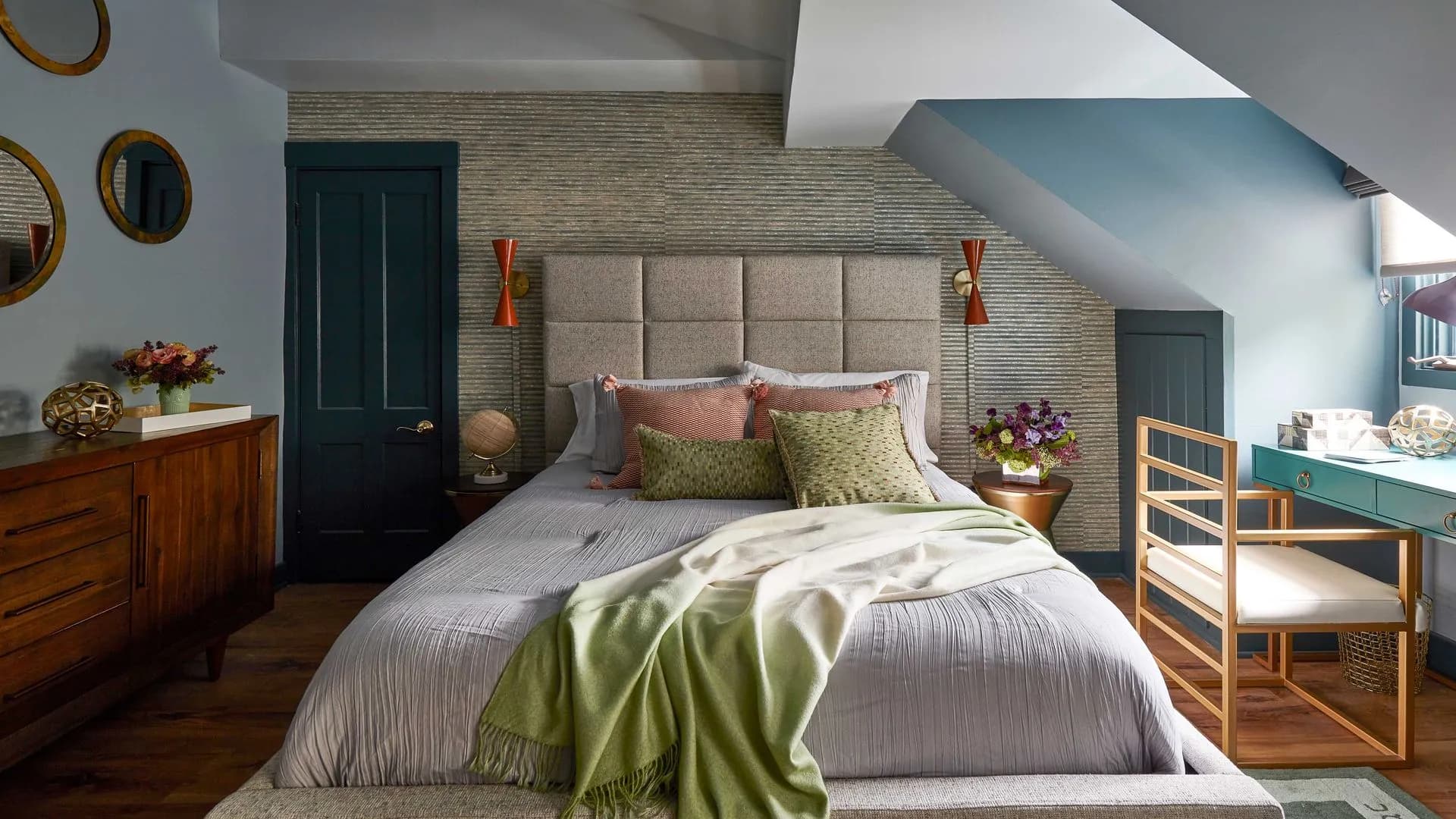 Modern bedroom with blue walls, textured wallpaper, and unique desk.