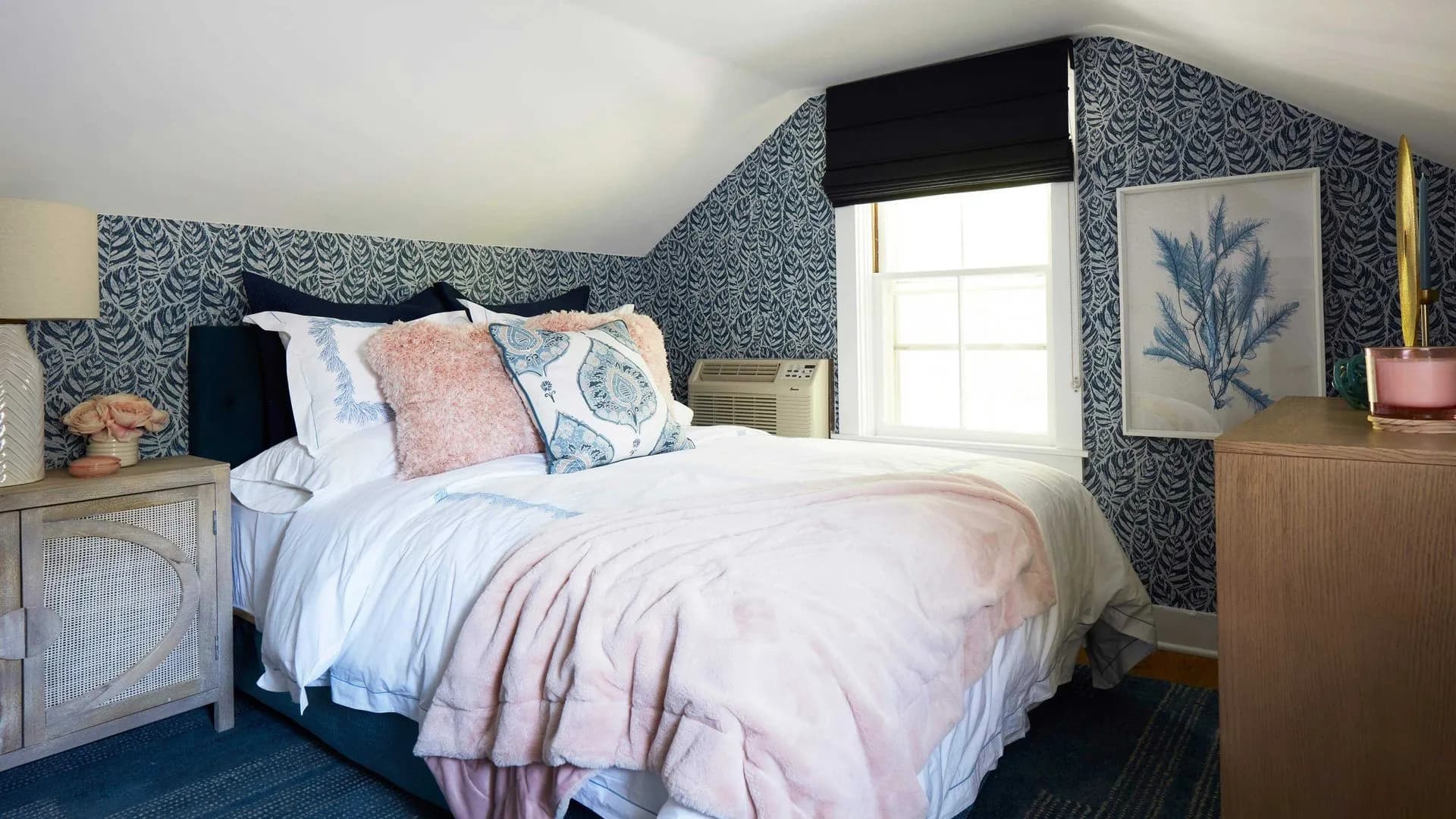 Blue and white bedroom with patterned wallpaper and a sloped ceiling.