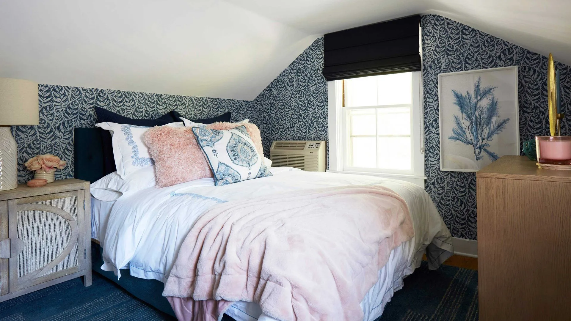 Blue and white bedroom with patterned wallpaper and a sloped ceiling.